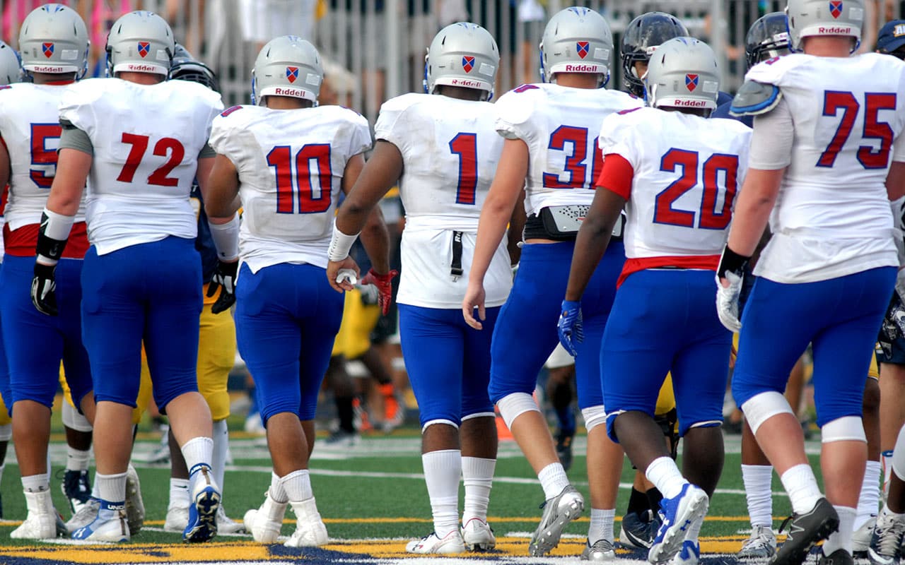 PG Football team greets opponents Averett University at conclusion of game in August 2017.