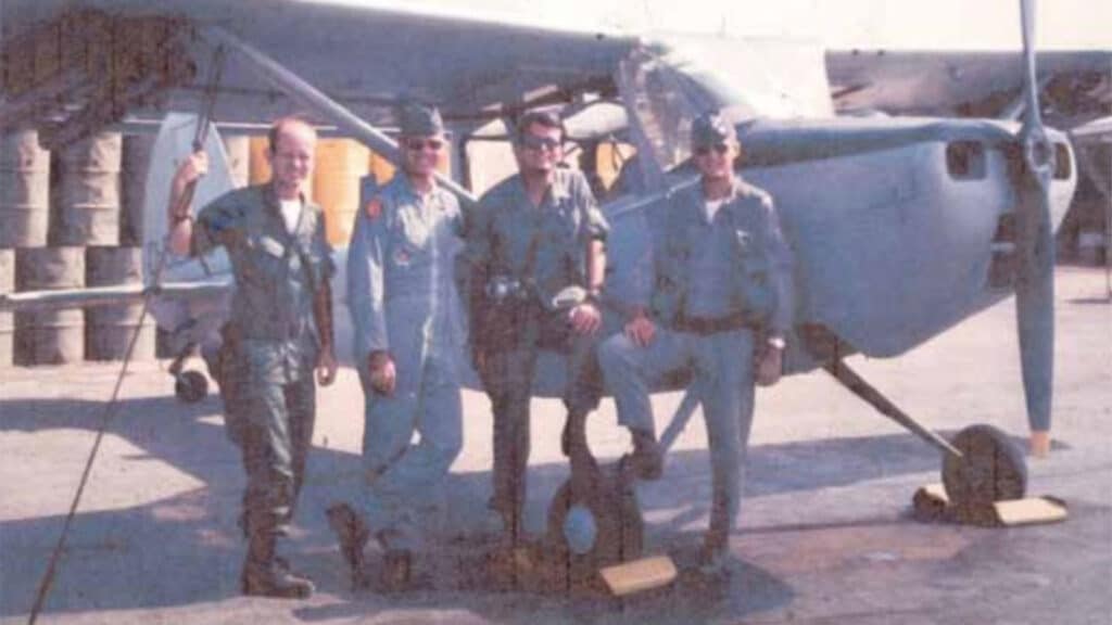 John Jackson (second from left) standing with members of his crew and a fellow FAC pilot in front of the light Cessna O-1 "Bird Dog"
airplane he piloted in Vietnam in 398 combat missions as a Forward Air Controller.