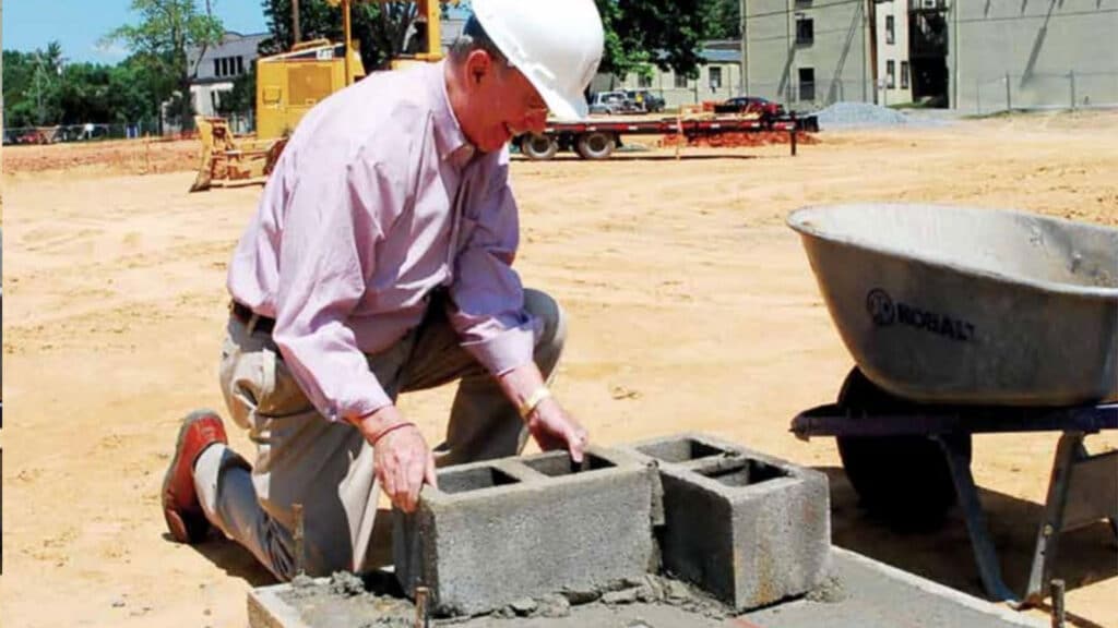 General Jackson lays the ceremonial first blocks at the cornerstone of the Jacobson Hall barracks building, his final capital project as President of Fork Union Military Academy.