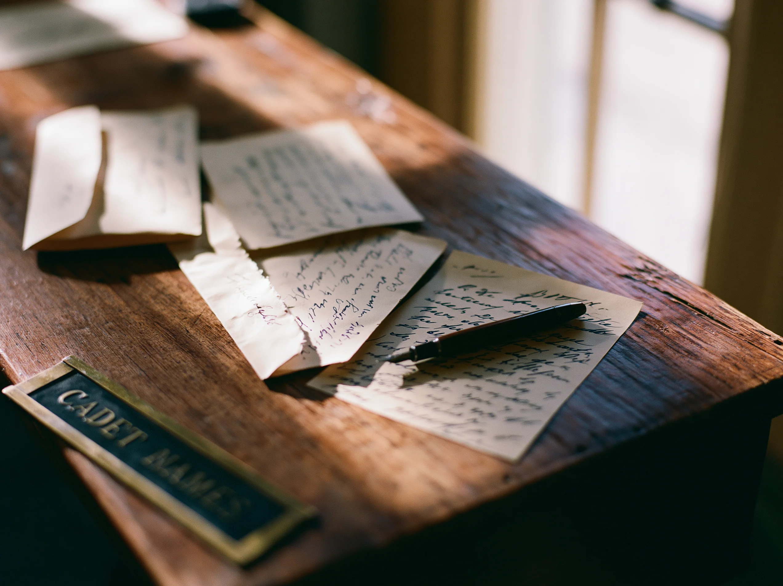Handwritten letters home on a cadet's wooden dorm desk at Fork Union Military Academy.