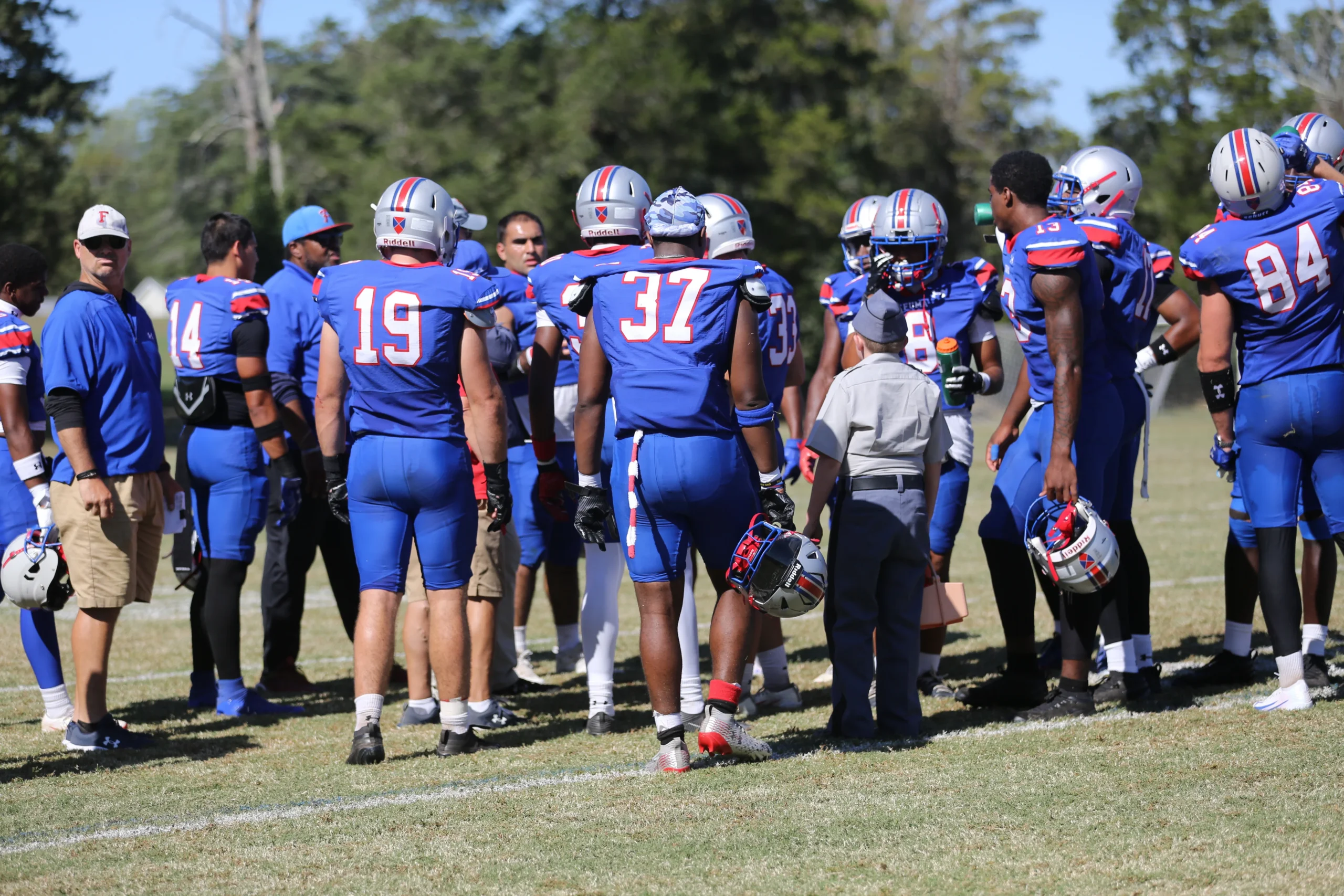 FUMA Postgraduate Football coaching staff on the sideline.