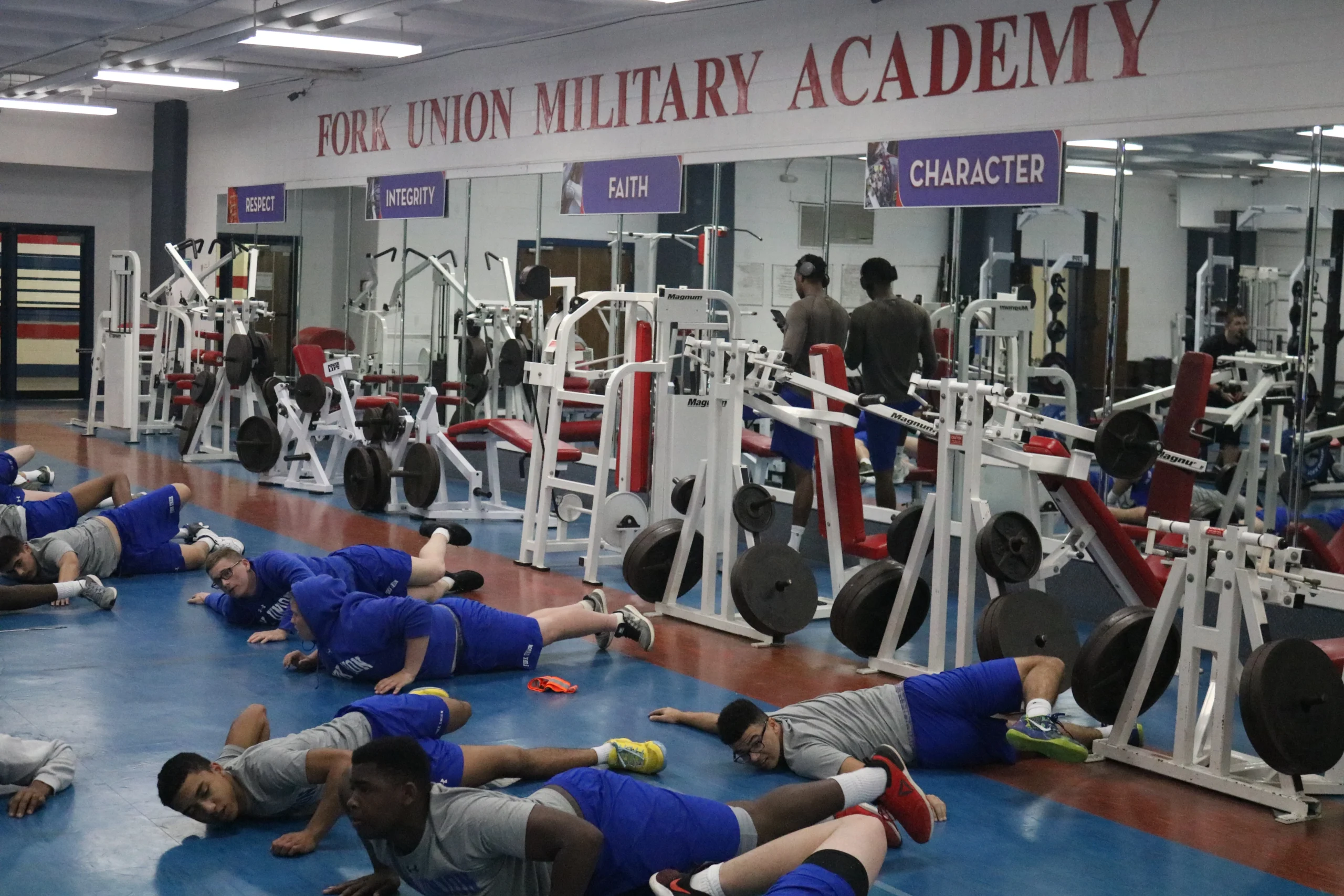 FUMA athletes in the weight room — postgraduate football training.